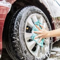 Man wash car using shampoo - every day life car care concept